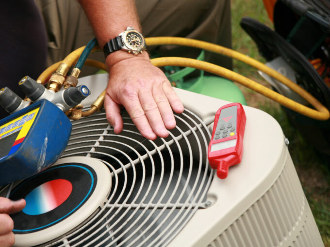 someone repairing an AC unit